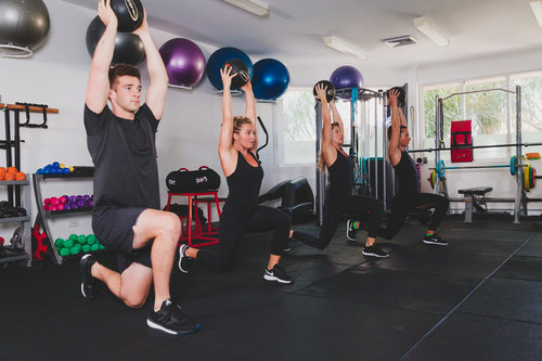 download a group of fitness enthusiasts building strength through workouts in a gym