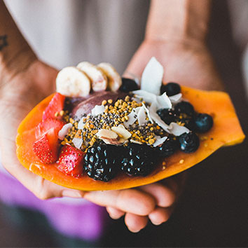 epicurrence-64520 a picture of papaya with different fruits and berries on top