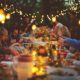 a group of people eating together in a long table