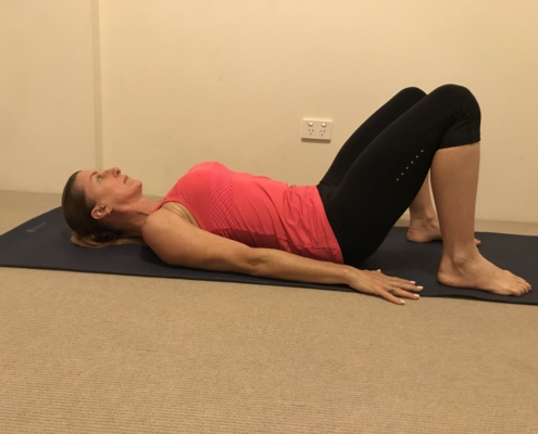 1A a picture of woman lying on her back on a yoga mat