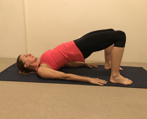 1B a picture of woman exercising her back doing the bridge pose