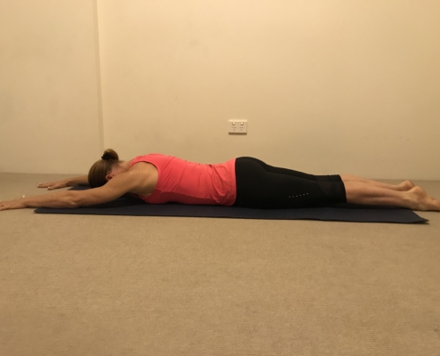 2A a woman lying face down on a mat