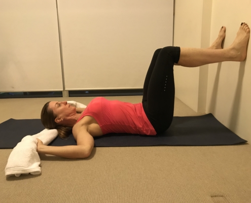 4A a picture of woman lying on her back with her feet on the wall