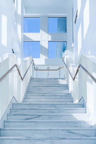 pasted image 0 (1) a picture of staircase and a white wall in a bright day
