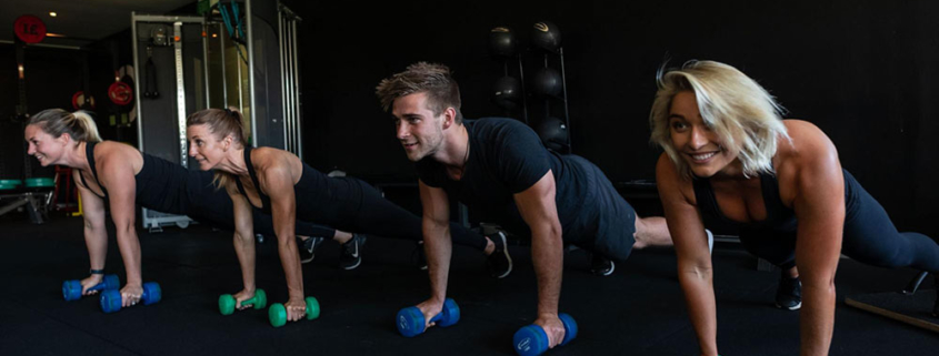 a group of fitness enthusiasts building strength through workouts in a gym