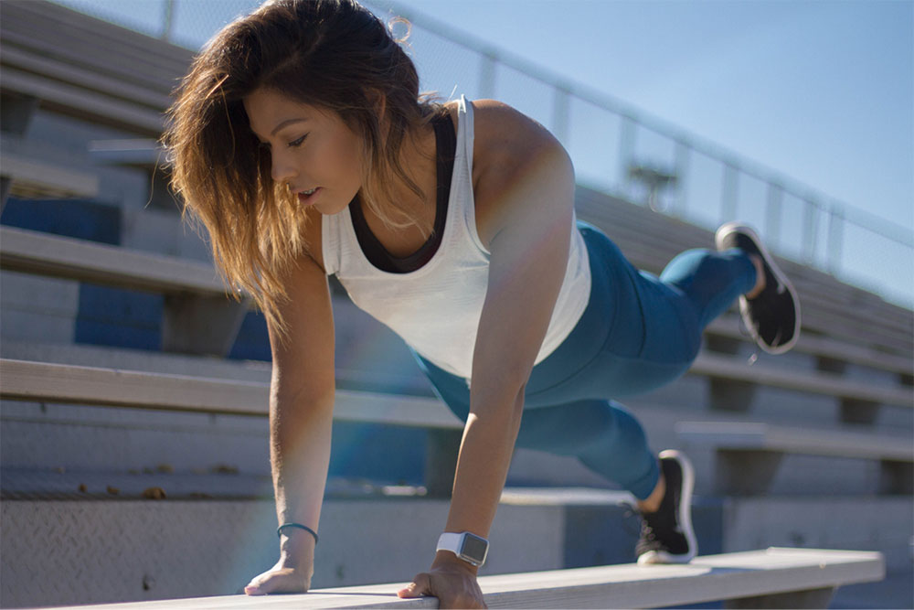 a picture of woman in a planking position outdoor