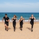 a group of people running happily at the beach